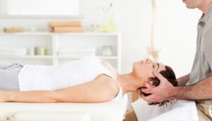 Chiropractor Adjustment of Woman in White Shirt, Image